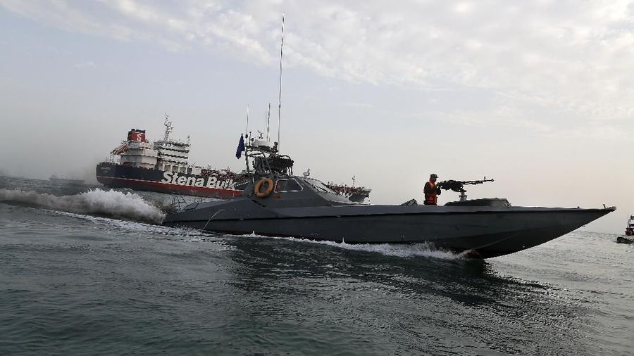A speedboat of the Iran's Revolutionary Guard moves around a British-flagged oil tanker Stena Impero, which was seized on Friday by the Guard, in the Iranian port of Bandar Abbas, Sunday, July 21, 2019. Iranian officials say the seizure of the British oil tanker was a justified response to Britain's role in impounding an Iranian supertanker two weeks earlier off the coast of Gibraltar, a British territory located on the southern tip of Spain. (Hasan Shirvani/Mizan News Agency via AP)