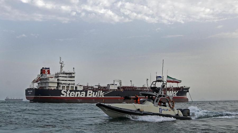 A speedboat of the Iran's Revolutionary Guard moves around a British-flagged oil tanker Stena Impero, which was seized on Friday by the Guard, in the Iranian port of Bandar Abbas, Sunday, July 21, 2019. Iranian officials say the seizure of the British oil tanker was a justified response to Britain's role in impounding an Iranian supertanker two weeks earlier off the coast of Gibraltar, a British territory located on the southern tip of Spain. (Hasan Shirvani/Mizan News Agency via AP)