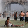 People cool off in the Trocadero fountains across from the Eiffel Tower in Paris as a new heatwave broke temperature records in France, July 25, 2019. REUTERS/Pascal Rossignol