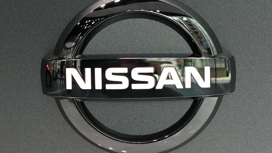 Nissan logo is seen at a Nissan car gallery Thursday, July 25, 2019, in Tokyo. Nissan says it will slash 12,500 jobs, about 9% of its global workforce, to cut costs, achieve turnaround toward growth.  (AP Photo/Eugene Hoshiko)