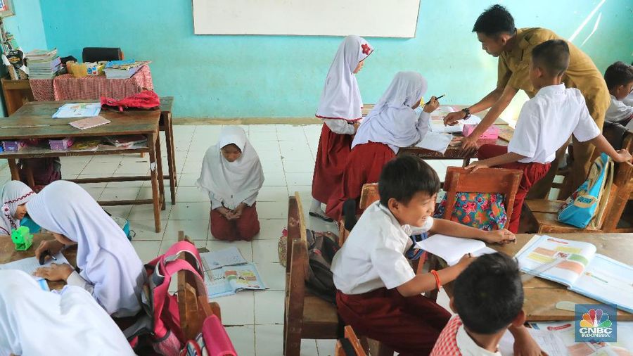 Akibat kekurangan bangku sejumlah siswa terpaksa disekolah tersebut harus duduk satu meja untuk tiga orang.