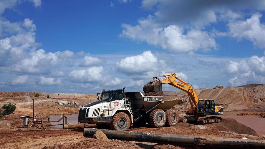 An excavator loads soil onto a truck at PT Timah's open pit mine in Pemali, Bangka island, Indonesia, July 25, 2019. REUTERS/Fransiska Nangoy