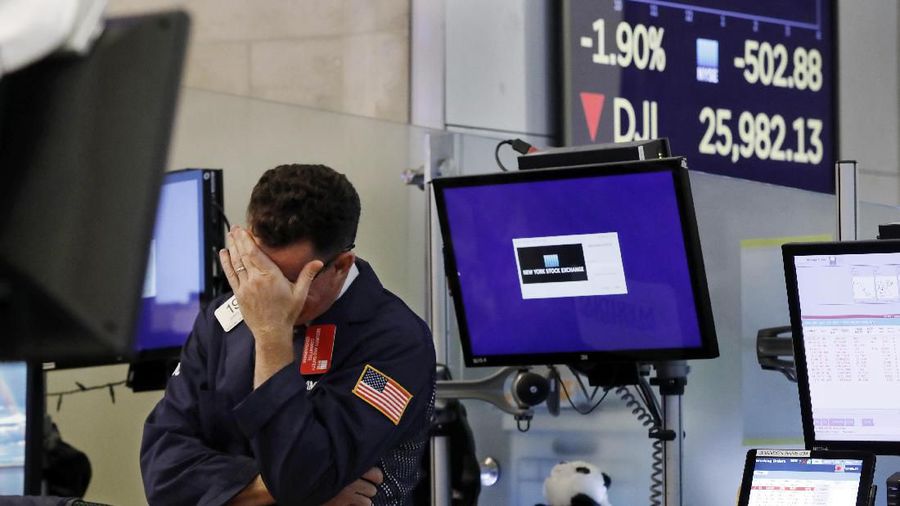 Trader Gregory Rowe works on the floor of the New York Stock Exchange, Monday, Aug. 5, 2019. Stocks plunged on Wall Street Monday on worries about how much President Donald Trump's escalating trade war with China will damage the economy. (AP Photo/Richard Drew)