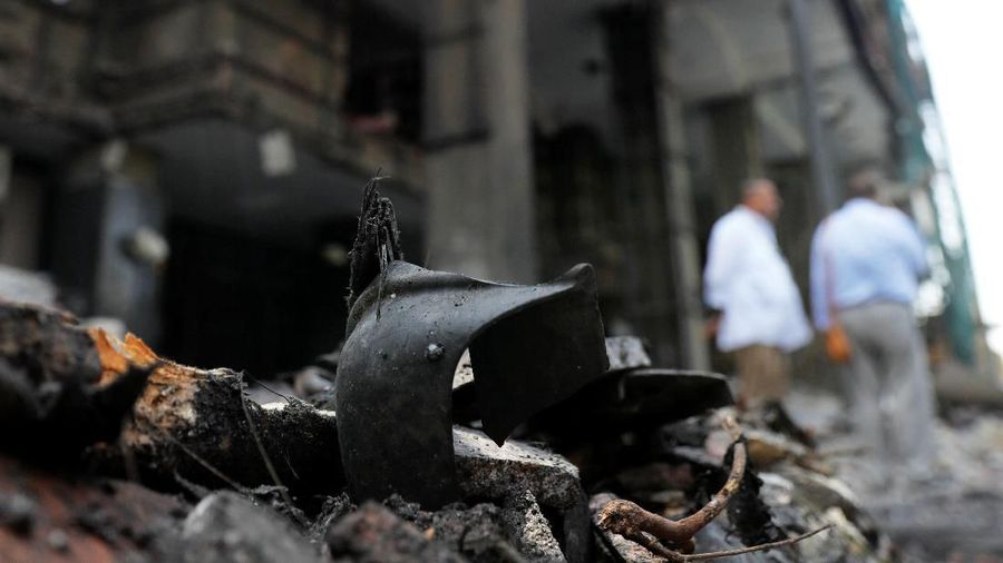 Belongings of victims are seen amid rubble in front of the damaged facade of the National Cancer Institute after an overnight fire from a blast, in Cairo, Egypt August 5, 2019. REUTERS/Amr Abdallah Dalsh