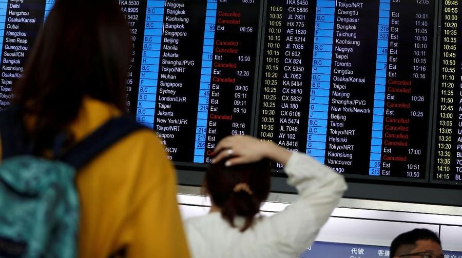 Passengers queue as the airport reopened a day after flights were halted due to a protest, at Hong Kong International Airport, China August 13, 2019. REUTERS/Issei Kato