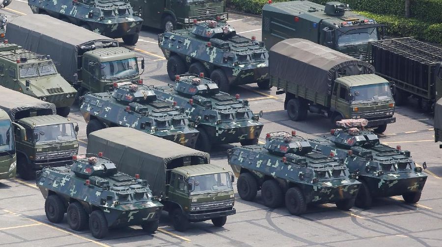 Military vehicles are parked on the grounds of the Shenzhen Bay Sports Center in Shenzhen, China August 15, 2019.  REUTERS/Thomas Peter