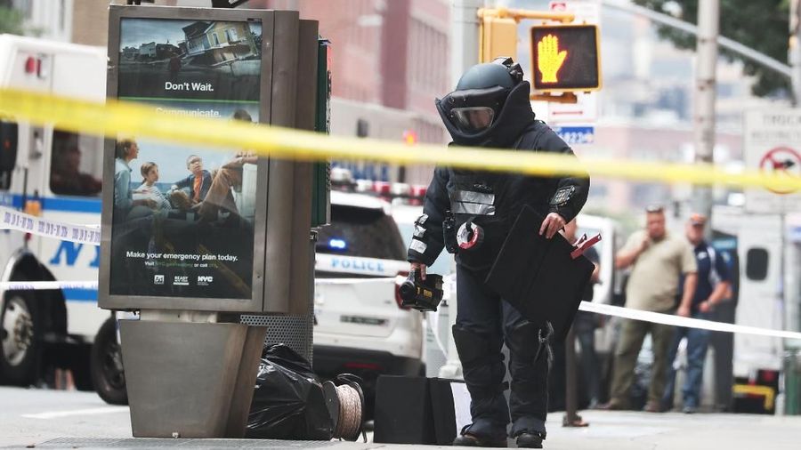 A NYPD Bomb Squad officer investigates suspicious packages near West 16th Street and Seventh Avenue as police were investigating suspicious packages in Manhattan, New York, U.S. August 16, 2019. REUTERS/Shannon Stapleton