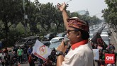 Setengah ruas Jalan Medan Merdeka Selatan dipenuhi mobil sopir taksi online. Mobil terparkir setidaknya tiga baris sepanjang perbatasan pagar Balai Kota hingga depan pagar Perpustakaan Nasional. (CNN Indonesia/Andry Novelino)