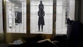 Seorang tunawisma tidur di luar toko Balenciaga di Madison Avenue di New York. (REUTERS/Ricardo Moraes).