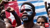 Ratusan pemuda beraksi dengan menggunakan atribut bendera bintang kejora, yang merupakan bendera yang diklaim sebagai negara West Papua, sekaligus mengibarkannya di depan Istana Merdeka. CNNIndonesia/Safir Makki