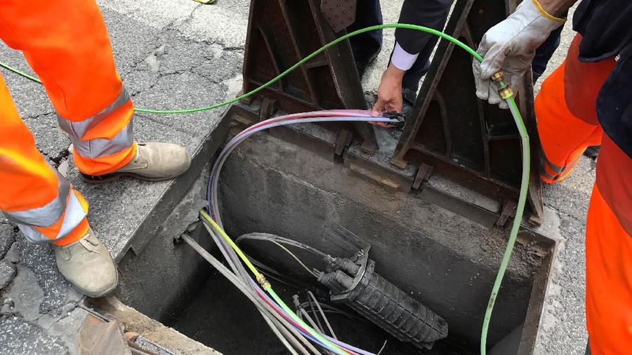 FILE PHOTO: Workers are seen installing fiber optic cables in Perugia, Italy, May 30, 2017. Picture taken May 30, 2017. REUTERS/Stephen Jewkes/File Photo