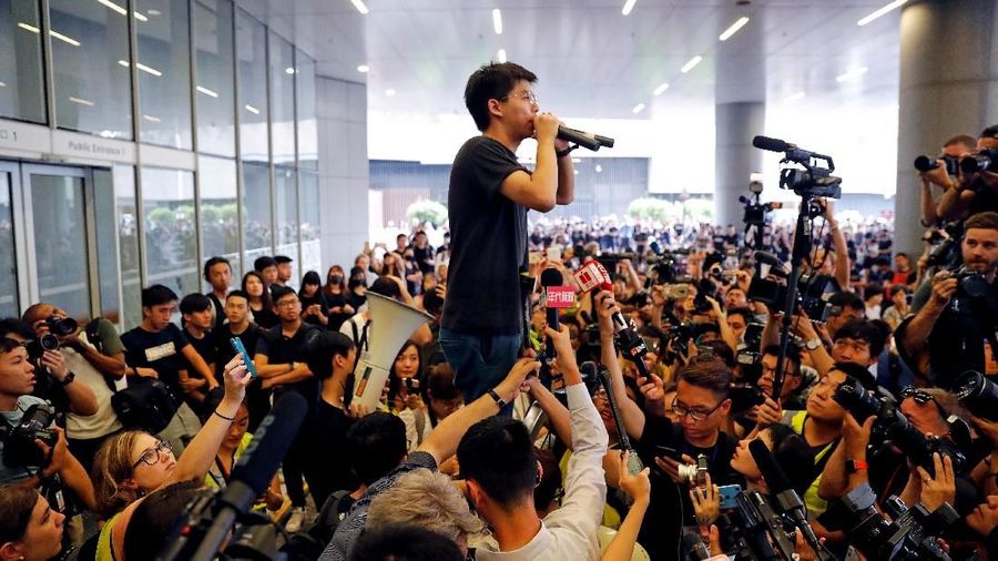 FILE PHOTO: Pro-democracy activist Joshua Wong addresses the crowds outside the Legislative Council during a demonstration demanding Hong Kong's leaders step down and withdraw the extradition bill, in Hong Kong, China June 17, 2019. REUTERS/Jorge Silva/File Photo To match Special Report HONGKONG-PROTESTS/PROTESTERS