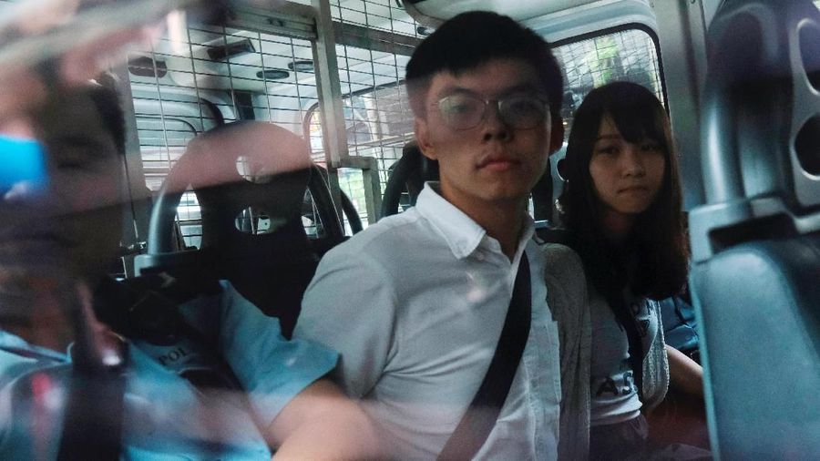 Pro-democracy activists Joshua Wong and Agnes Chow arrive at the Eastern Court by police van after being arrested on suspicion for organising illegal protests, in Hong Kong, China August 30, 2019. REUTERS/Tyrone Siu