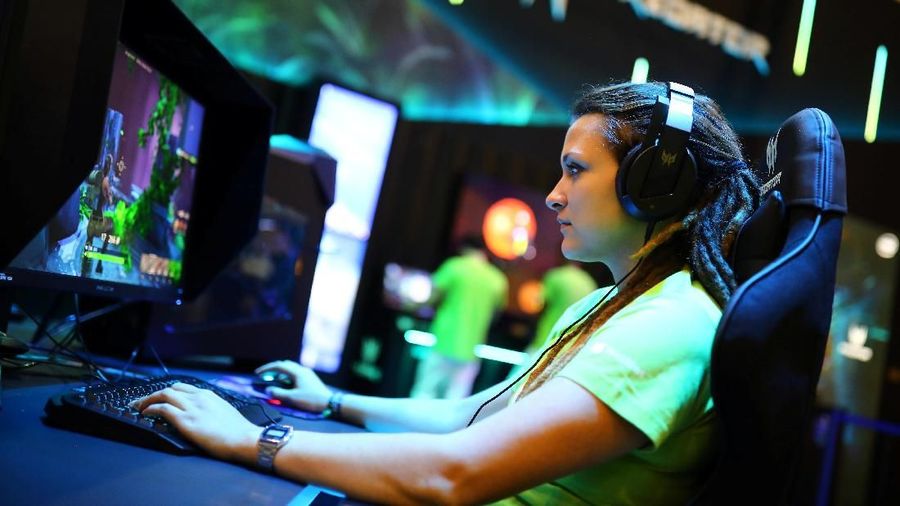 A woman plays on a computer at the IFA consumer electronics fair in Berlin, Germany, September 4, 2019. REUTERS/Hannibal Hanschke