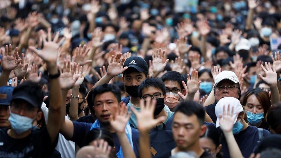 People hold signs and attend a rally to the U.S. Consulate General in Hong Kong, China, September 8, 2019. REUTERS/Anushree Fadnavis
