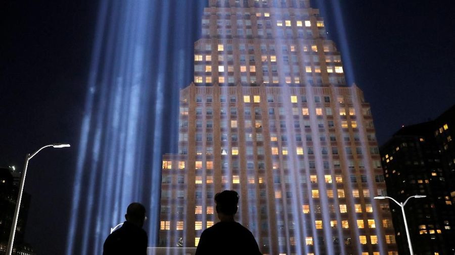 People look toward the Tribute in Light, lit to commemorate the 18th anniversary of September 11, 2001 attacks in New York City, U.S., September 10, 2019. REUTERS/Andrew Kelly