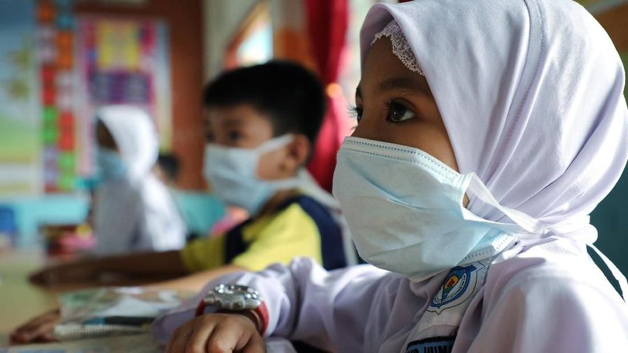 Students cover their faces with masks at a school as haze shrouds Kuala Lumpur, Malaysia, September 13, 2019. REUTERS/Lim Huey Teng