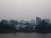 A boat passes by a residential area shrouded in haze in Putrajaya, Malaysia, September 17, 2019. REUTERS/Lim Huey Teng
