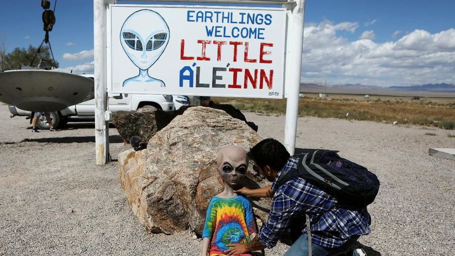 An attendee poses an alien doll at the Little A'Le'Inn as an influx of tourists responding to a call to 'storm' Area 51, a secretive U.S. military base believed by UFO enthusiasts to hold government secrets about extra-terrestrials, is expected in Rachel, Nevada, U.S. September 19, 2019. REUTERS/Jim Urquhart