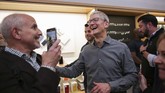 CEO Apple Tim Cook ber-selfie ria dengan para karyawan serta meladeni permintaan berfoto dengan konsumen dalam pembukaan penjualan iPhone 11 itu. (Photo by Kena Betancur / AFP)