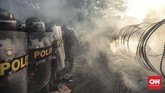 Polisi memasang barikade dan mengadang massa yang hendak menuju DPR. Massa menyebut polisi sebagai penjahat demokrasi karena menghalangi aksi. (CNN Indonesia/Bisma Septalisma).