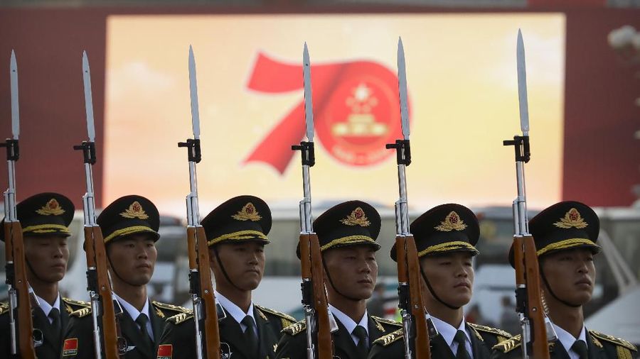 Chinese soldiers march in formation during a rehearsal before a large parade to commemorate the 70th anniversary of the founding of Communist China in Beijing, Tuesday, Oct. 1, 2019. Chinese Communist Party leader and President Xi Jinping on Monday renewed his government's commitment to allowing Hong Kong to manage its own affairs amid continuing anti-government protests in the semi-autonomous Chinese territory. (AP Photo/Mark Schiefelbein)