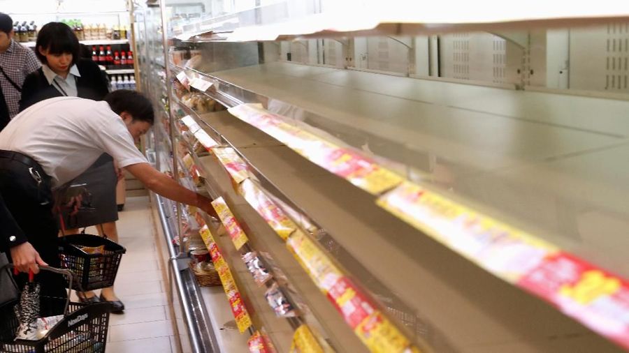 A customer looks for food on the racks inside a convenience store at Tokyo Station in Tokyo, Japan, ahead of Typhoon Hagibis October 12, 2019. REUTERS/Kim Kyung-hoon