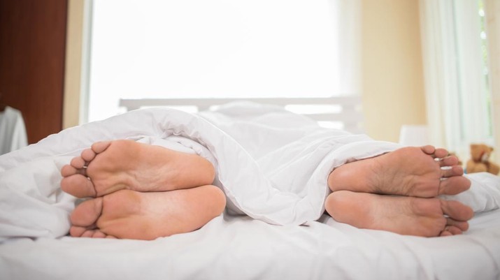 Feet of couple facing away from each other.