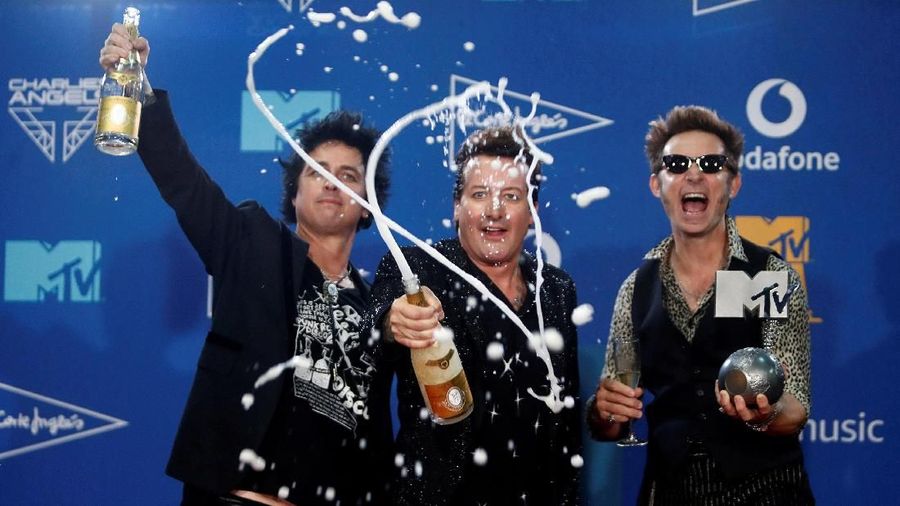 Green Day members celebrate with champagne at the backstage during the 2019 MTV Europe Music Awards at the FIBES Conference and Exhibition Centre in Seville, Spain, November 3, 2019. REUTERS/Jon Nazca TPX IMAGES OF THE DAY