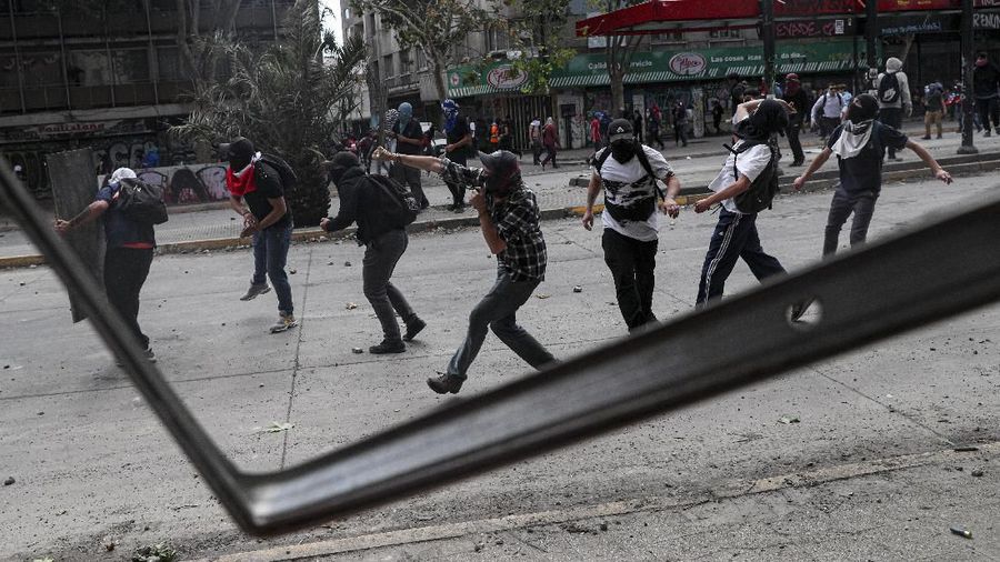 Para demonstran anti-pemerintah berbenturan dengan polisi selama demonstrasi di Santiago, Chili