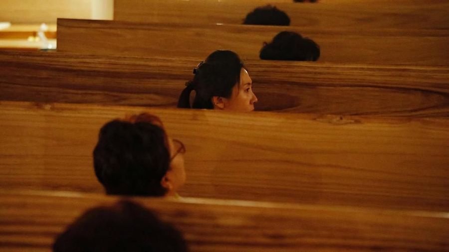 A participant poses for a funeral portrait during a 