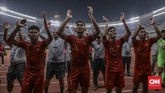 Para pemain Timnas Indonesia U-19 merayakan keberhasilan lolos ke putaran final Piala Asia U-19 2020 bersama suporter. (CNN Indonesia/Bisma Septalisma)