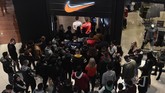 Penduduk Yunani mengantre di depan toko pakaian olahraga Nike di Thessaloniki dalam perayaan hari diskon belanja tahunan, 'Black Friday' pada Jumat (29/11). (Photo by Sakis Mitrolidis / AFP)