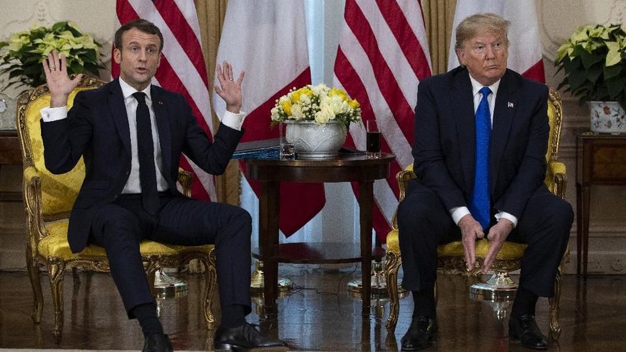 An interpreter translates for President Donald Trump as French President Emmanuel Macron speaks during a meeting at Winfield House during the NATO summit, Tuesday, Dec. 3, 2019, in London. (AP Photo/ Evan Vucci)