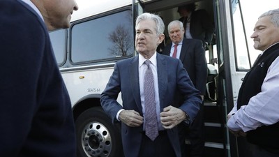 FILE - In this Nov. 25, 2019, file photo Federal Reserve Board Chair Jerome Powell, center, steps off a bus and greets people during tour of East Hartford, Conn. On Wednesday, Dec. 11, the Federal Reserve issues a statement and economic projections, followed by a news conference with Powell. (AP Photo/Steven Senne, File)