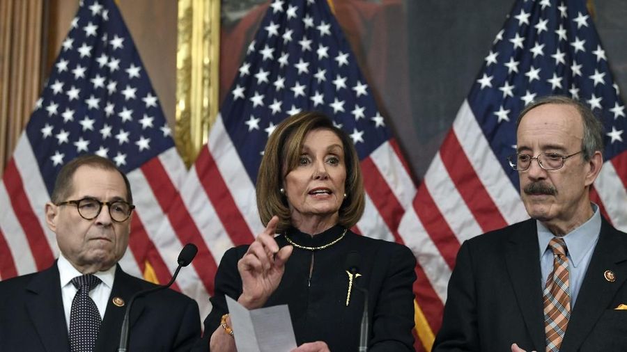 House Speaker Nancy Pelosi, D-Calif., speaks on Capitol Hill in Washington, Wednesday, Dec. 18, 2019, takes questions from reporters after the House of Representatives voted to impeach President Donald Trump on two charges, abuse of power and obstructing Congress, as House Judiciary Committee Chairman Rep. Jerrold Nadler, D-N.Y., and Chairman of the House Foreign Affairs Committee Eliot Engel, D-N.Y., listen. (AP Photo/Susan Walsh)