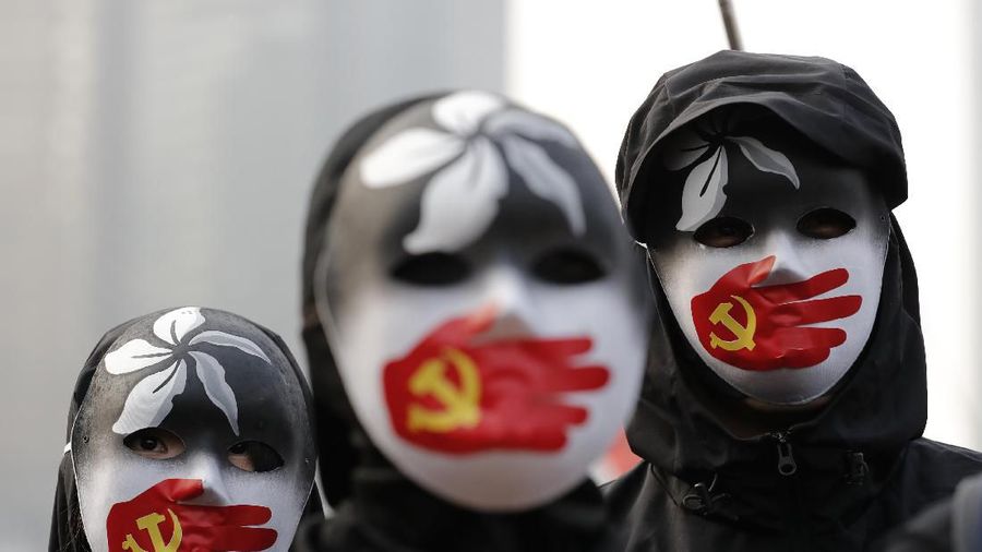 Riot policemen arrest protesters during a rally to show support for Uighurs and their fight for human rights in Hong Kong, Sunday, Dec. 22, 2019. Thousands of demonstrators attended a rally to protest against China's policy about Uighur minority. (AP Photo/Lee Jin-man)