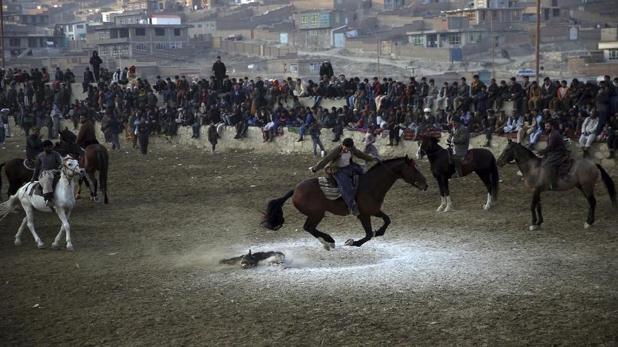 Afghan horse riders compete for the goat during a friendly buzkashi match on the outskirts of Kabul, Afghanistan, Friday, Dec. 27, 2019. Buzkashi is a traditional and the national sport of Afghanistan, where players compete to place a goat carcass into a goal circle. It was banned during the Taliban rule. (AP Photo/Rahmat Gul)