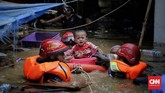 Petugas pemadam kebakaran mengevakuasi warga saat banjir di Kampung Pulo, Jakarta, Kamis (2/1/2020). (CNN Indonesia/ Adhi Wicaksono)