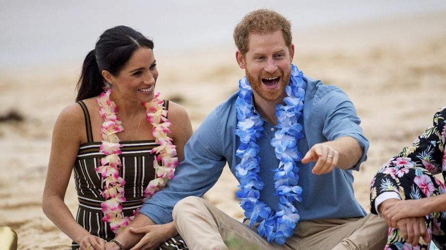 FILE - In this Friday, Oct. 19, 2018 file photo Britain's Prince Harry and Meghan, Duchess of Sussex meet with a local surfing community group, known as OneWave, raising awareness for mental health and wellbeing in a fun and engaging way at Bondi Beach in Sydney, Australia. In a stunning declaration, Britain's Prince Harry and his wife, Meghan, said they are planning