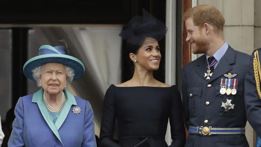 FILE - In this Tuesday, July 10, 2018 file photo Britain's Queen Elizabeth II, and Meghan the Duchess of Sussex and Prince Harry watch a flypast of Royal Air Force aircraft pass over Buckingham Palace in London. In a stunning declaration, Britain's Prince Harry and his wife, Meghan, said they are planning
