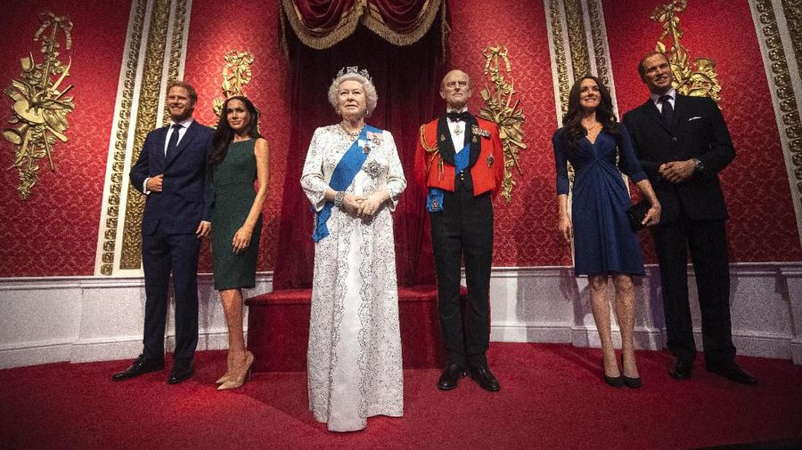 The figures of Britain's Prince Harry and Meghan, Duchess of Sussex, left, in their original positions next to Queen Elizabeth II, Prince Philip and Prince William and Kate, Duchess of Cambridge, at Madame Tussauds in London, Thursday Jan. 9, 2020. Madame Tussauds moved its figures of Prince Harry and Meghan, Duchess of Sussex from its Royal Family set to elsewhere in the attraction. (Victoria Jones/PA via AP)