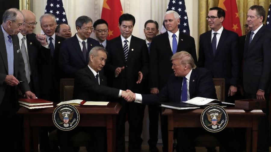 President Donald Trump shakes hands with Chinese Vice Premier Liu He, after signing a trade agreement in the East Room of the White House, Wednesday, Jan. 15, 2020, in Washington. (AP Photo/Evan Vucci)