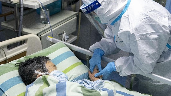 In this Friday, Jan. 24, 2020, photo released by China's Xinhua News Agency, a medical worker attends to a patient in the intensive care unit at Zhongnan Hospital of Wuhan University in Wuhan in central China's Hubei Province. China expanded its lockdown against the deadly new virus to an unprecedented 36 million people and rushed to build a prefabricated, 1,000-bed hospital for victims Friday as the outbreak cast a pall over Lunar New Year, the country's biggest, most festive holiday. (Xiong Qi/Xinhua via AP)