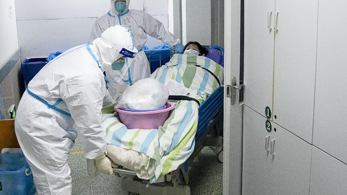 In this Friday, Jan. 24, 2020, photo released by China's Xinhua News Agency, a medical workers transfer a patient out of the intensive care unit at Zhongnan Hospital of Wuhan University in Wuhan in central China's Hubei Province. China expanded its lockdown against the deadly new virus to an unprecedented 36 million people and rushed to build a prefabricated, 1,000-bed hospital for victims Friday as the outbreak cast a pall over Lunar New Year, the country's biggest, most festive holiday. (Xiong Qi/Xinhua via AP)