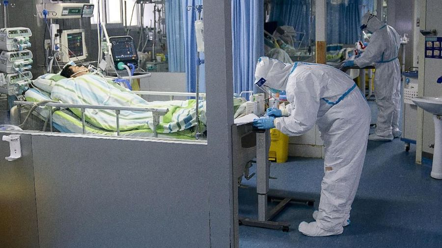 In this Friday, Jan. 24, 2020, photo released by China's Xinhua News Agency, a medical worker attends to a patient in the intensive care unit at Zhongnan Hospital of Wuhan University in Wuhan in central China's Hubei Province. China expanded its lockdown against the deadly new virus to an unprecedented 36 million people and rushed to build a prefabricated, 1,000-bed hospital for victims Friday as the outbreak cast a pall over Lunar New Year, the country's biggest, most festive holiday. (Xiong Qi/Xinhua via AP)