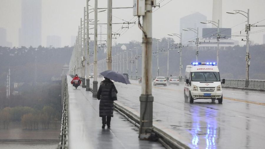 An ambulance drives across a bridge in Wuhan in central China's Hubei province, Saturday, Jan. 25, 2020. The virus-hit Chinese city of Wuhan, already on lockdown, banned most vehicle use downtown and Hong Kong said it would close schools for two weeks as authorities scrambled Saturday to stop the spread of an illness that is known to have infected more than 1,200 people and killed 41, according to officials. (Chinatopix via AP)