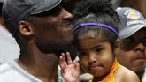 Kobe Bryant menggendong Gianna usai Los Angeles Lakers mengalahkan Orlando Magic pada final NBA 2009. (Stephen M. Dowell/Orlando Sentinel via AP)