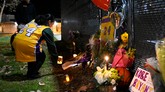 Seorang fan Christina Espinoza menaruh lilin sebagai benturk penghormatan untuk Kobe Bryant yang meninggal akibat kecelakaan helikopter di Calabasas, California. (AP Photo/Kelvin Kuo)