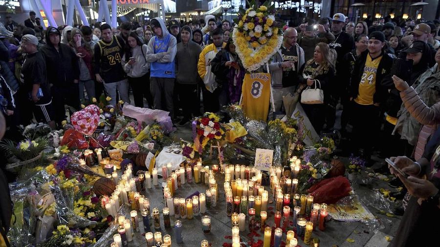 Fans membawa bunga dan topi, kaus dan memorabilia lainnya sebagai penghormatan kepada mantan bintang bola basket Los Angeles Lakers.